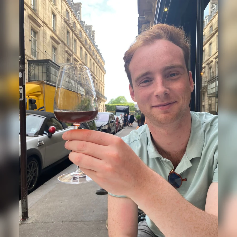 Gus holding a glass of wine